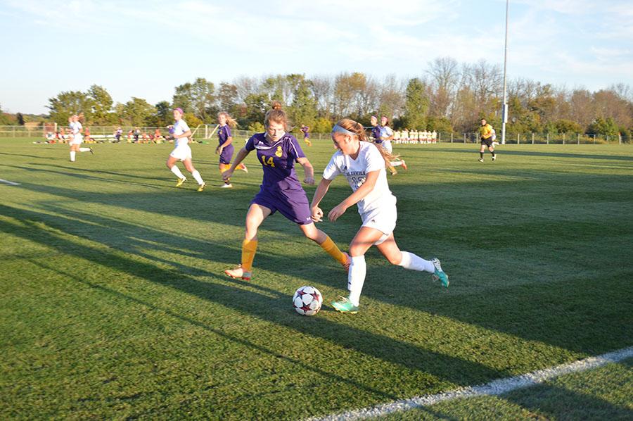 Sophomore Delany Riester battles a Marion opponent. The girls soccer team moves into sectional play this week.