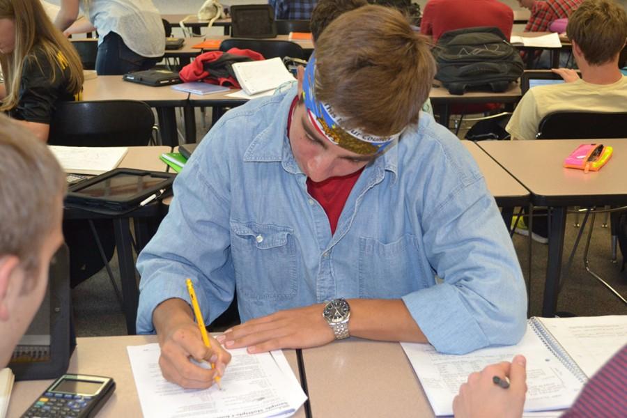 Senior Kai Strubel works on a Microeconomics assignment. Strubel is the current valedictorian of the class of 2015 and the President of the National Honor Society.