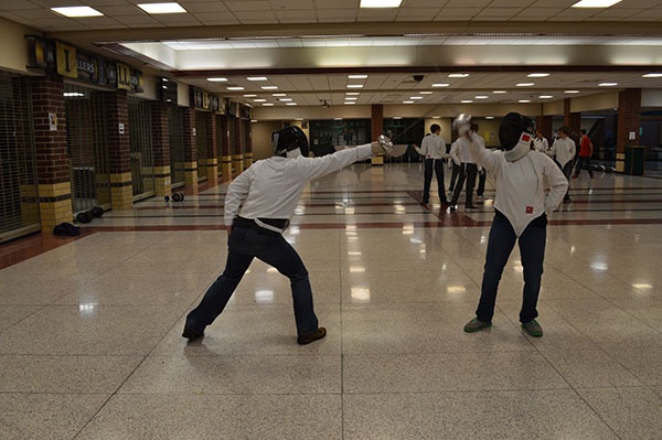 Benton Wolke strikes against Sierra Macmillan. These two are the only ones on the Epee team