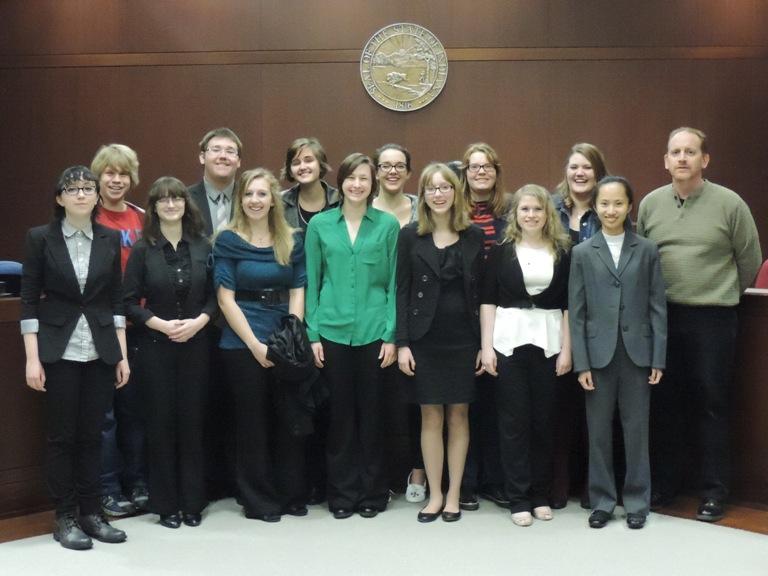 Both NHS mock trial teams pose for a picture in a county courtroom. The student lawyers and witnesses have been preparing for the weekly competitions and the tournament in February.