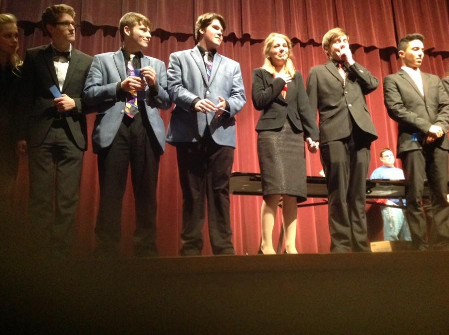 Senior Karlee Kopp and Freshman Ben Elliott start to cry on stage after qualifying for the National Speech Tournament in Memorized Duo. Seniors Blake Robinson and Sam Fields, State Champions in Memorized Duo, applaud them.