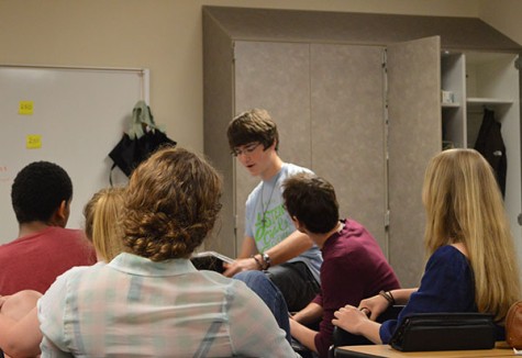 While students and co-leader Jordan look on, Osgood explains the crux of the Bible verse read earlier at the meeting. In bringing their Christian faith into the school, the leaders of the club hope to not only aid Christian students and attendees, but help the entire NHS community in working with and through Hallway Ministries members.