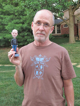 Photography teacher Craig Ryan poses with a bobble head. Ryan is retiring from NHS after 26 years of teaching.