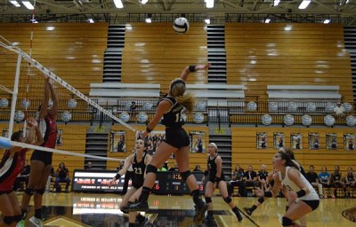 Junior Josie Sanders hits the ball across the net at the first girls varsity game of the season. The girls won three out of five sets on Tuesday.