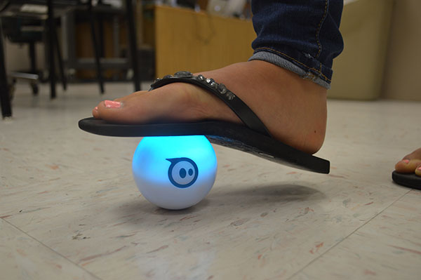 NHS Junior, Laney Harris, tests the durability of the sphero robot ball. Club members will be able to control and navigate the sphero.