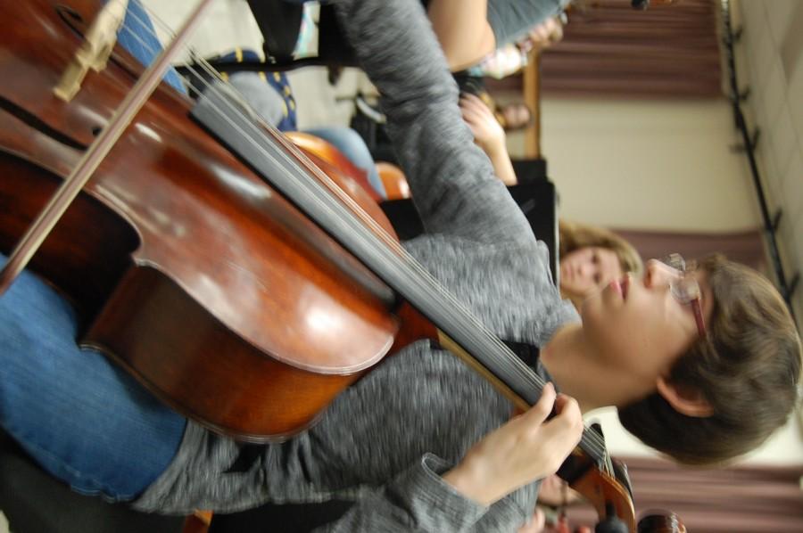 MacMillan plucks and plays in the second block Advanced Orchestra class. The orchestra’s most recent concert was the Holiday Concert on December 3.