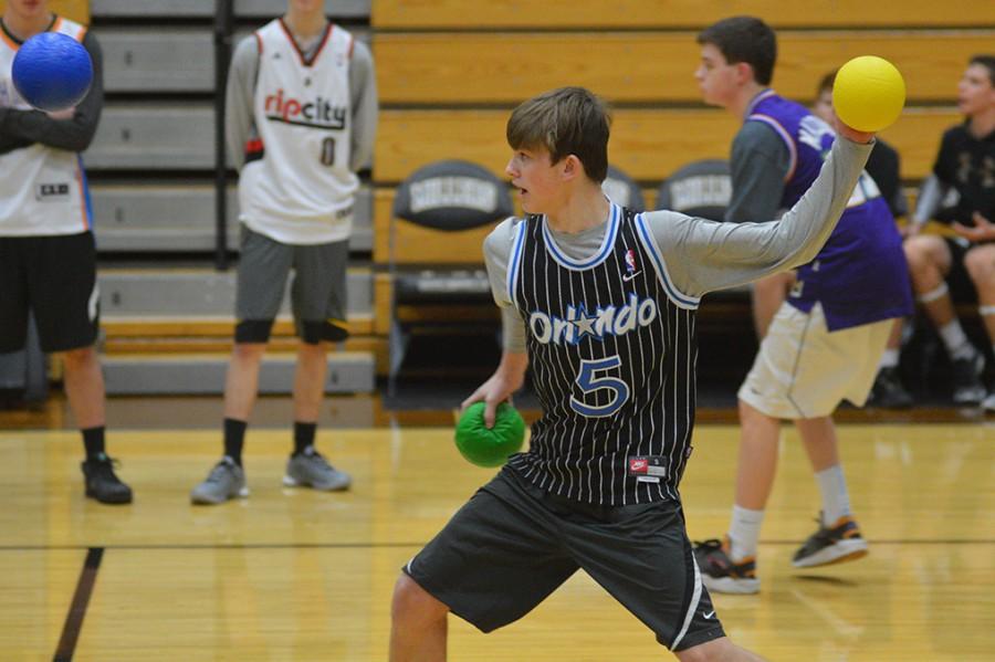 Sophomore+Jay+Justak+competes+during+the+students+versus+teachers+dodgeball+game.+The+tournament+occurred+in+the+main+gym+on+January+21.