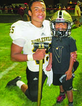  Ja’shaun Dickman poses for a picture with his little brother, Daniel Laning, after a football game with the 11      hammer. 