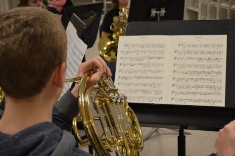 Freshman Trevor Zavac practices the French Horn choir's music selection during an AL practice. Zavac organized the French horn choir's rehearsal schedule, helping to keep them on track for the state competition.
