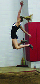 Freshman Maria Anderson jumps during one of her indoor track meets. Anderson has already broken the school record in the  long jump. 