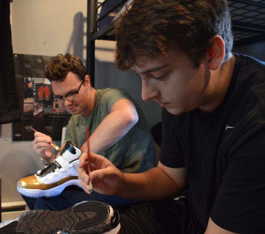 Bollenbacher and Braun work on a fresh pair of Jordan 11 “Closing Ceremony.” Braun purchased the shoes the day they were released and the duo aimed to be the first to deliver a custom job on the shoe, by painting all white surfaces on the shoes black.