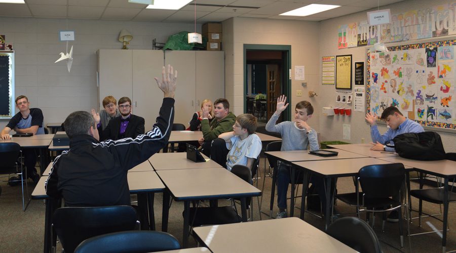 Students show hands on who would like to change from iPads to computers. 