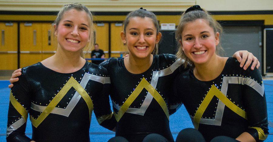 Elizabeth, Madeline and Veronica VanBuskirk pose for a picture between events at a home gymnastics meet. Home gymnastics meets are hosted at Noblesville East Middle School. 