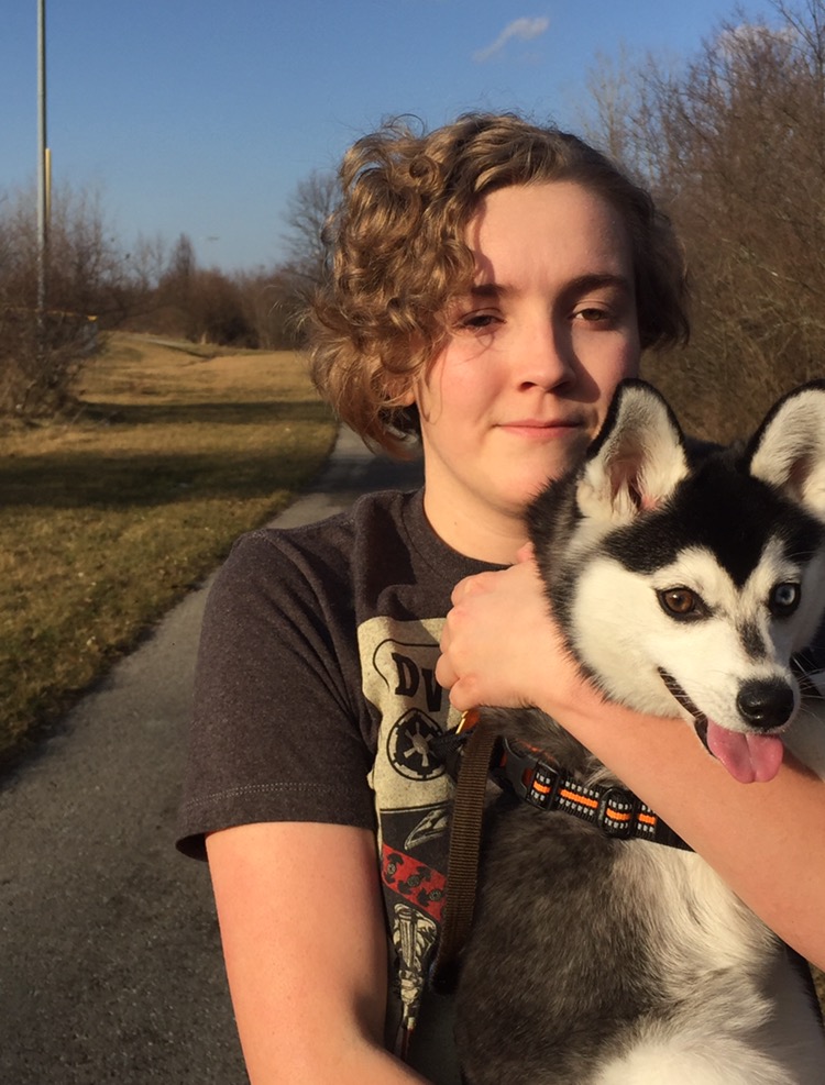 Alyssa Barnes carries Kitto along a trail near Hazel Dell Woods. In addition to walking him, Barnes says she enjoys taking Kitto to dog parks and the Noblesville Farmers Market. 