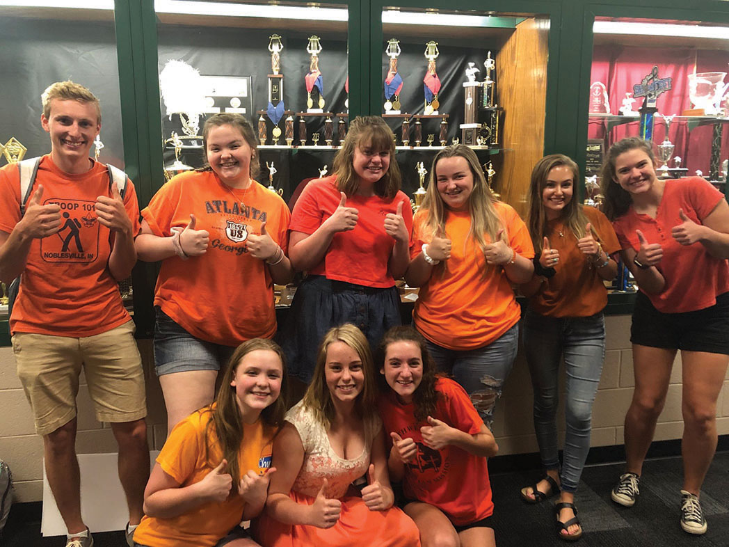 Kennedi Ulman (fourth from the left) and other
members of the group wear orange to protest gun violence.