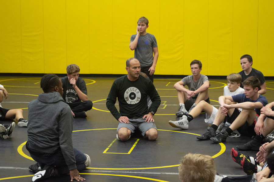 Coach Weimer dresses his team during a wrestling practice.