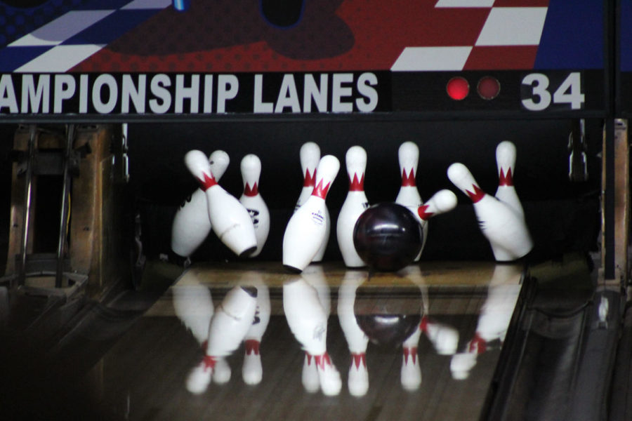 One NHS bowling teammate goes for a strike. 