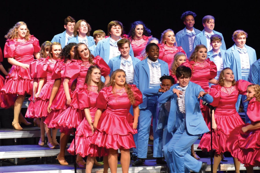 Singers performing at the Fishers show choir competition. The groups theme for their set is The Wedding Singer.