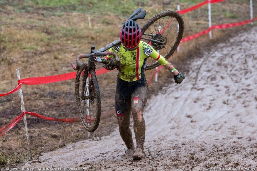 Baker hauls her bike through the mud during a race. Photo provided by Ajay Baker