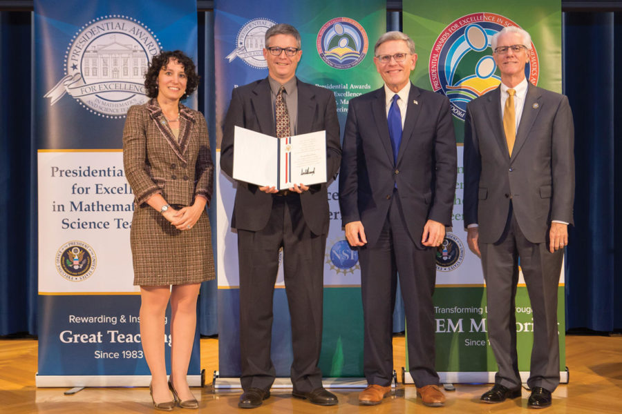 David Ferris poses for a photo in Washington D.C., holding his award.