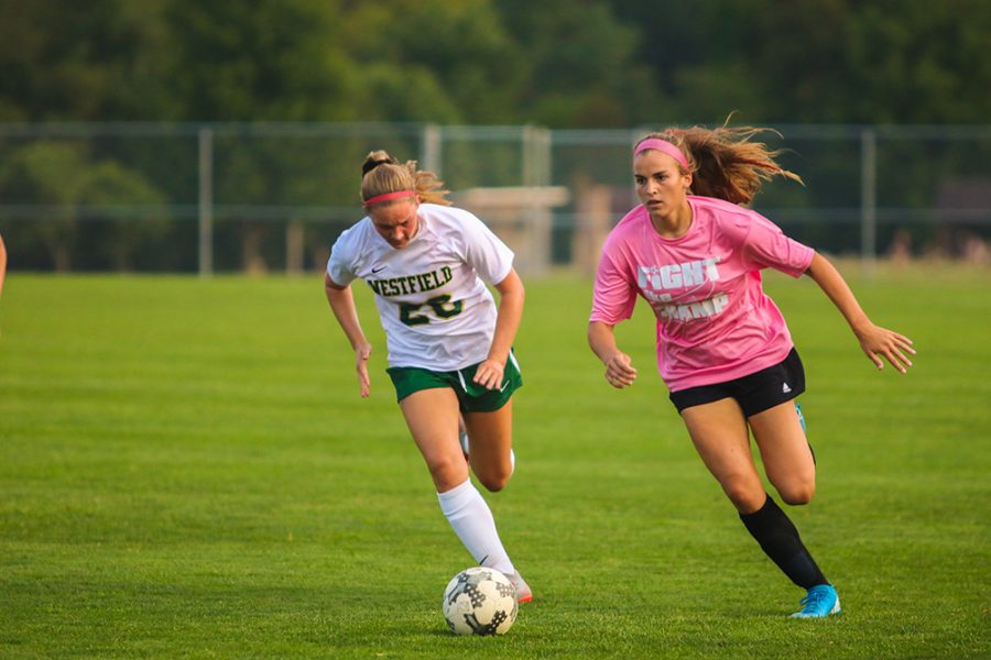 Kiana Siefert steals the ball from the opposing team. As she sprints down field, she takes the ball to score.