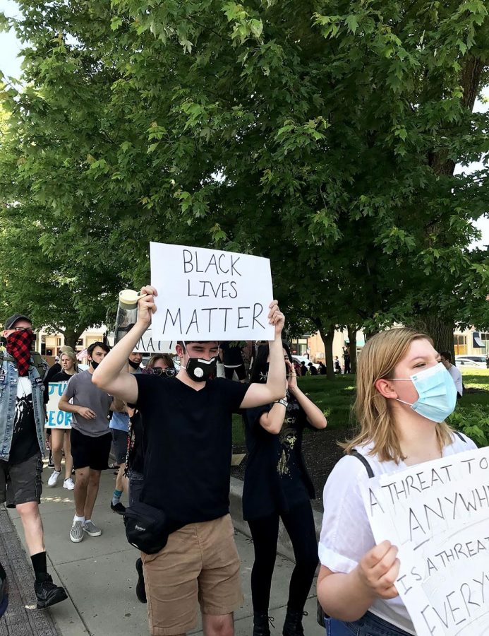 Equipped with signs and megaphones, NHS students took to the square to protest.