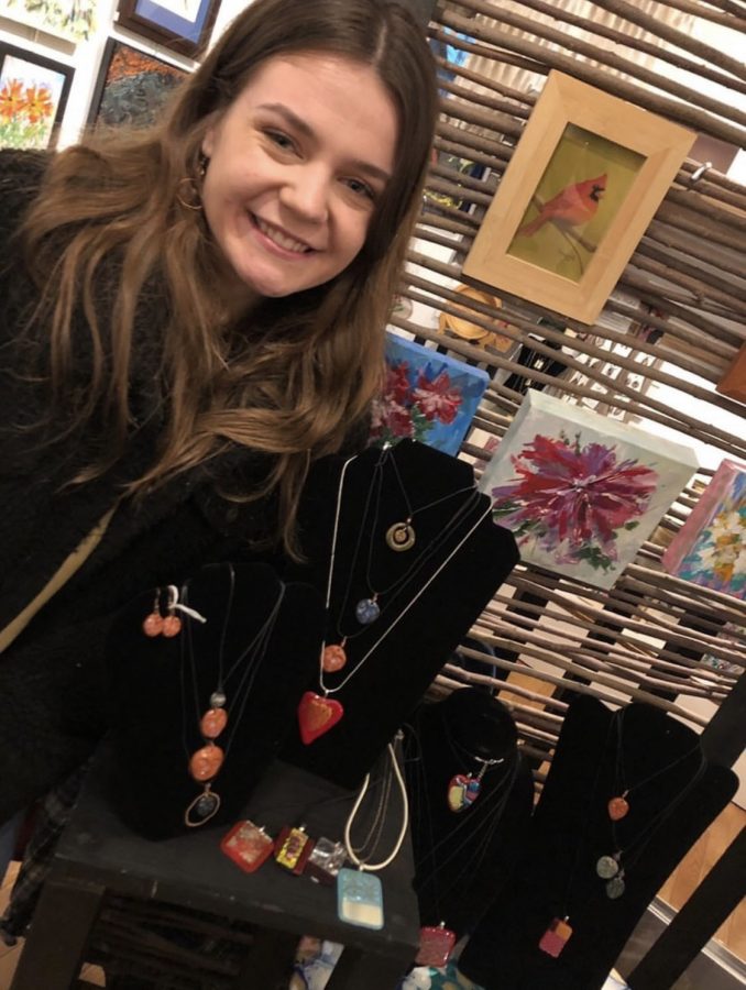 Madison Tomes shows off her handmade jewelry.