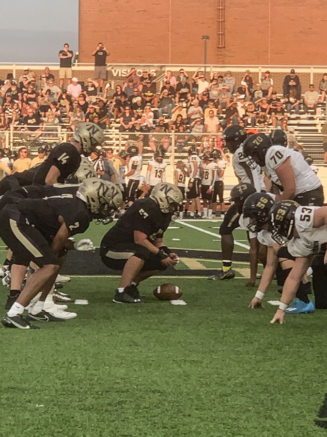 Freshman Quarterback Landon Hughes (14) lines up before a play. Hughes helped the Millers defeat Mt. Vernon by a score of 43-35. 