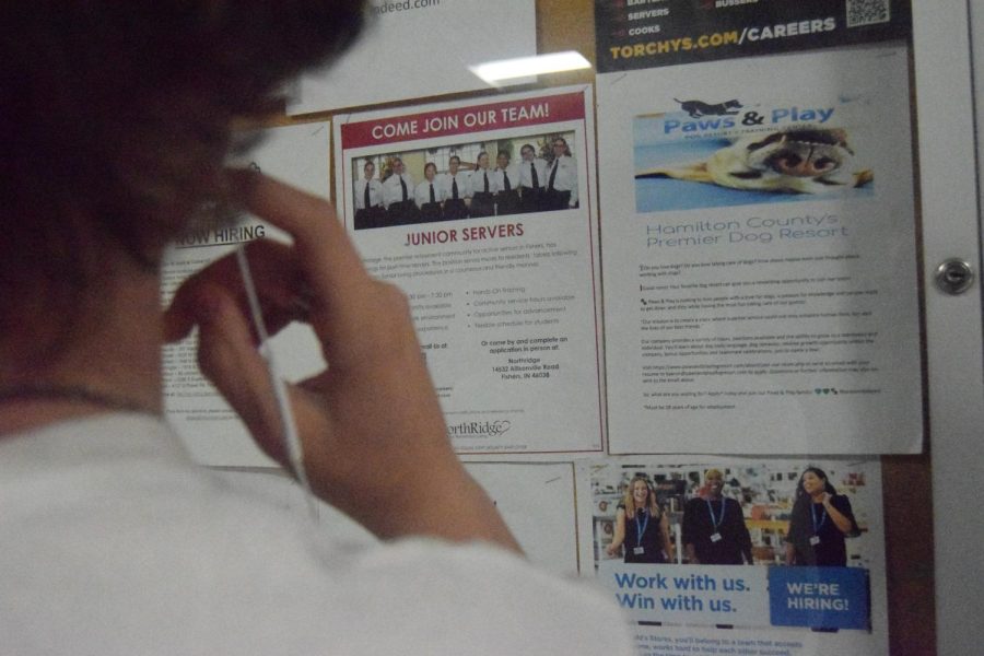 A student look at the NHS career board, carefully contemplating the options available.