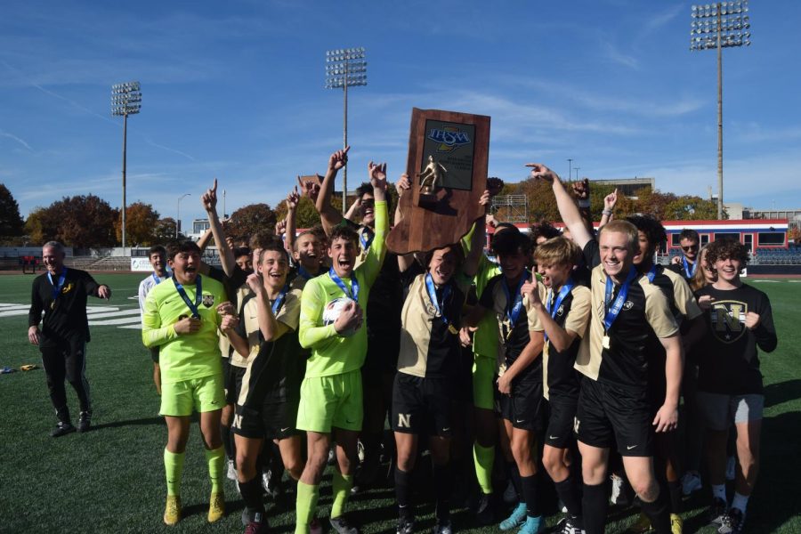 The+boys+team+celebrates+with+the+state+title+trophy+after+defeating+Columbus+North+1-0.+They+are+now+back-to-back+state+champions.