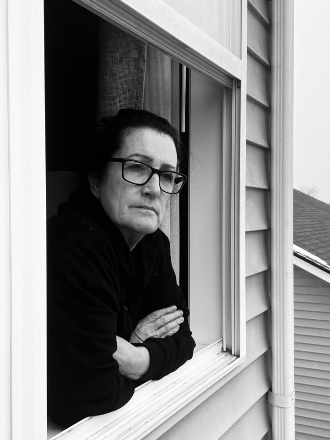 Laura Baker peers outside her window on a cold winters day. Baker has battled with accepting her wrinkles as she grows older.