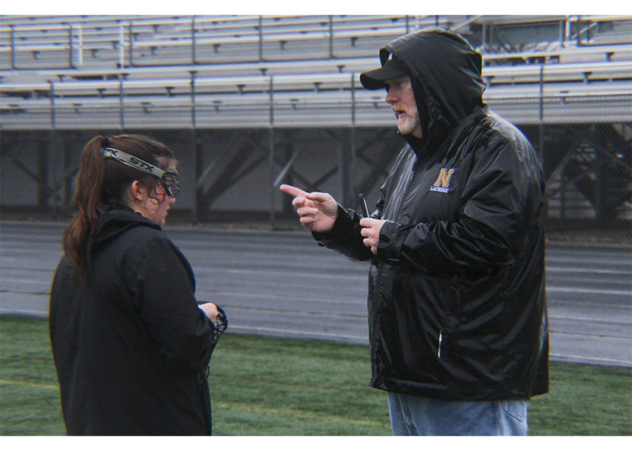 Jason Barnett, NHS Lacrosse coach, advises player, Emma Hammond, during practice. Players say their practices are becoming even more valuable as the first games of the season have begun.