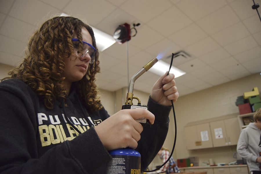 An engineering student uses a blowtorch to complete her work.
Photo credits: M. Vitale