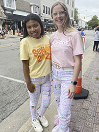Mackenzie Downs and Mileidy Cruz-Munoz show off their Senior Cords. Senior cords are white pants you decorate with your favorite high school memories.