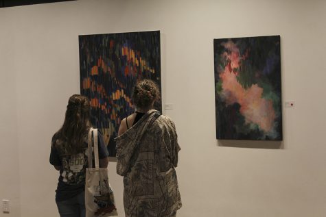 Two students view artwork at the Harrison Center. The Harrison Center is located downtown Indianapolis and houses the artwork of students from NHS’s ESJ class.