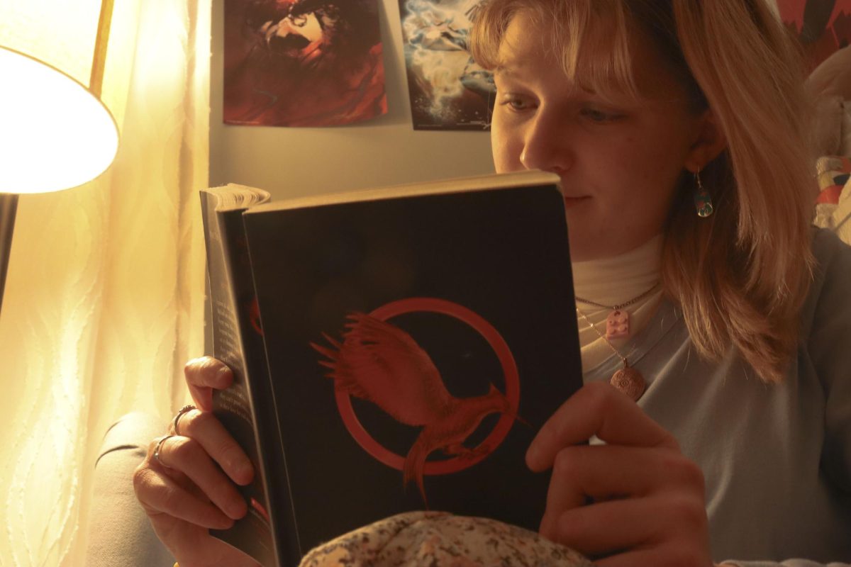 Kiersten York rereads the first “Hunger Games” book. “‘The Hunger Games’ was one of the first book series I had ever read,” York said.
