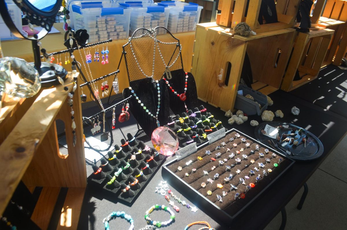Grey Calvert displays their several creations in their tent, Noblesville Rocks. This includes many of their handmade beaded rings and bracelets.
