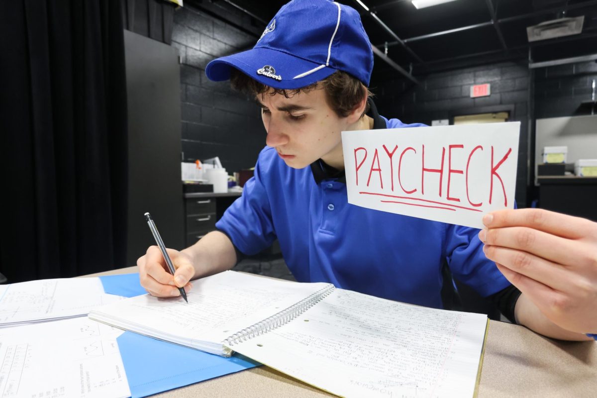 Junior Jack Fentz completes homework before a shift at Culver's. Like many NHS students, his part-time job overlaps with his academic responsibilities.